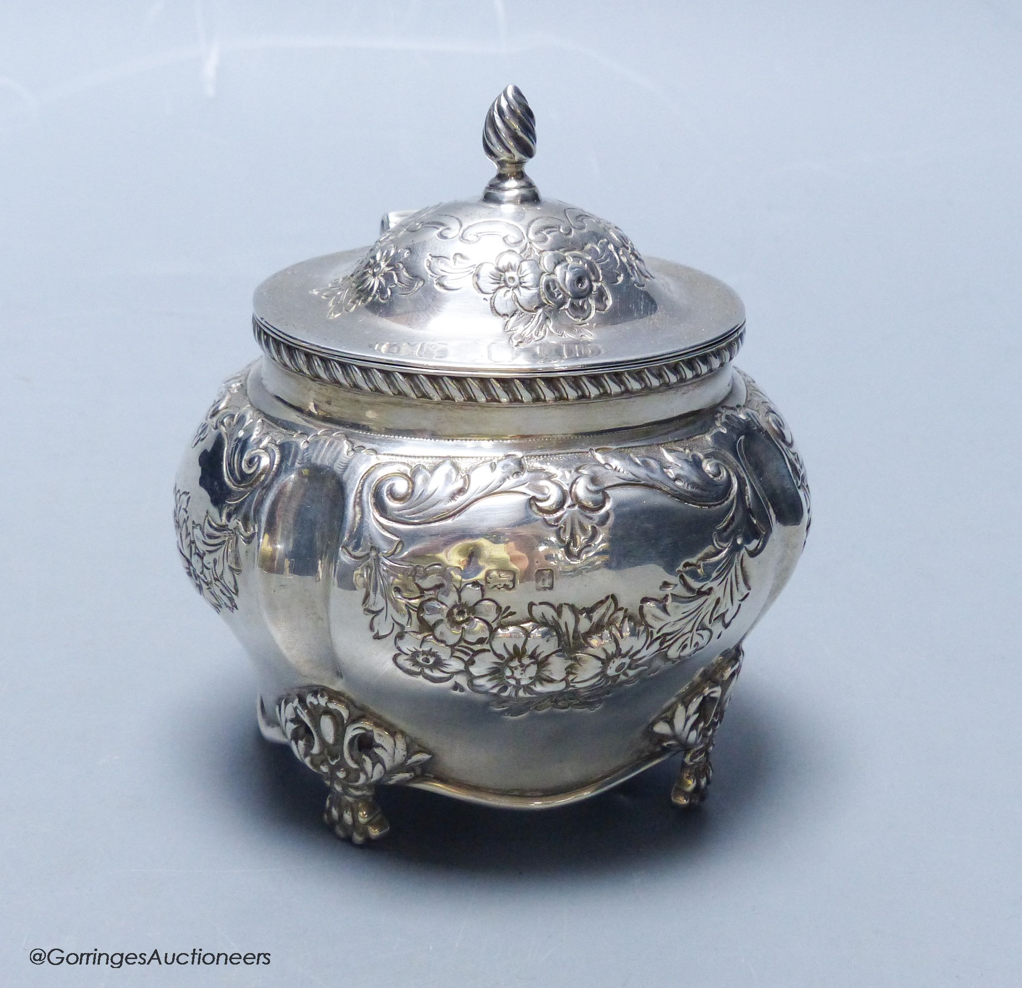 An Edwardian embossed silver bombe shaped tea caddy, Williams (Birmingham) Ltd, Birmingham, 1903, height 11cm, 5.5oz.